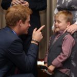 Il principe Harry parla con un bambino